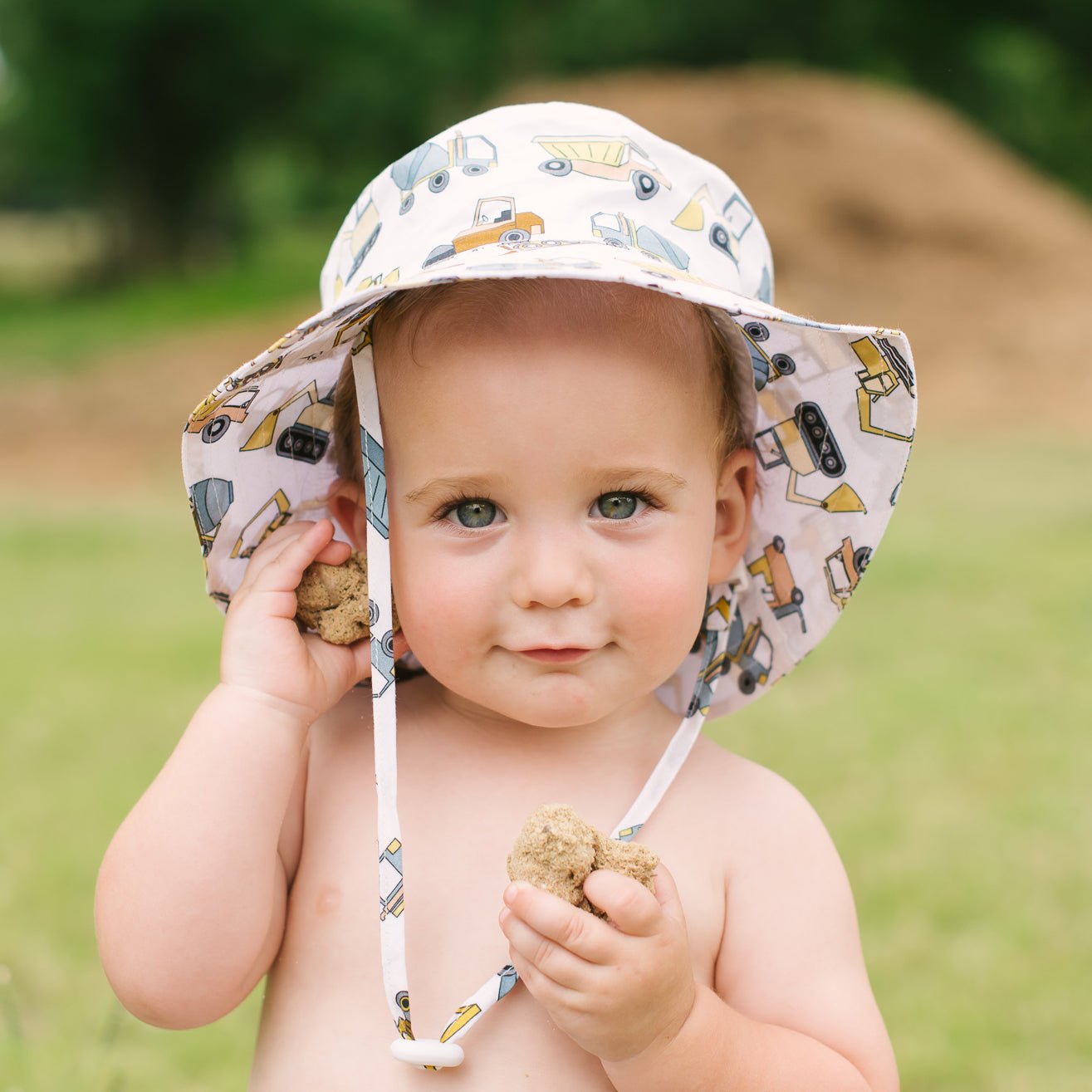Infant bucket hat with strap outlet
